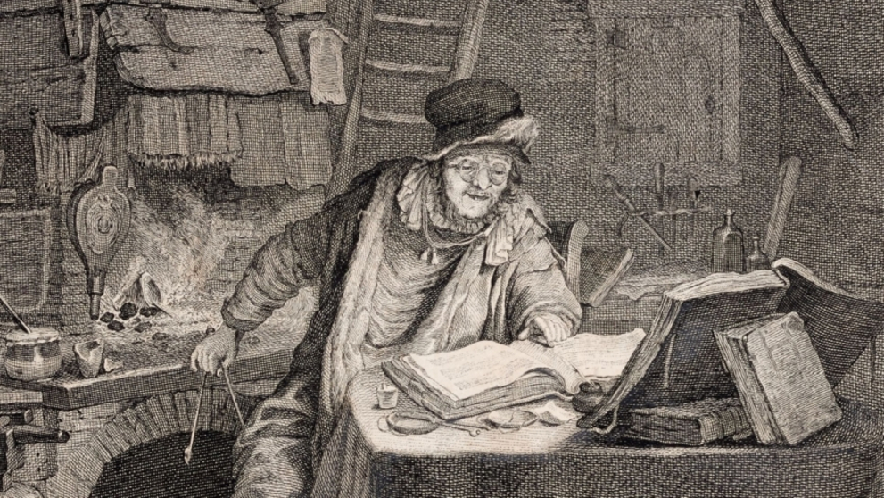 The historical etching shows a man with glasses and a cap, surrounded by books, reagent bottles and instruments, sitting and working in his laboratory by a fire. 