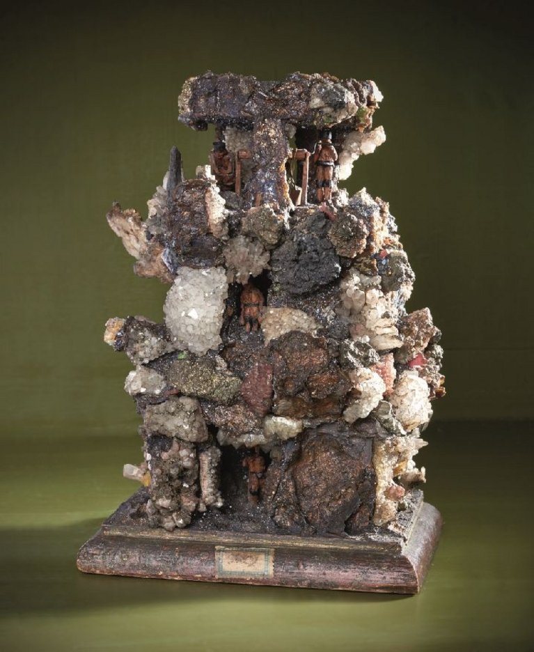 The handstone is a small sculpture of a mine.