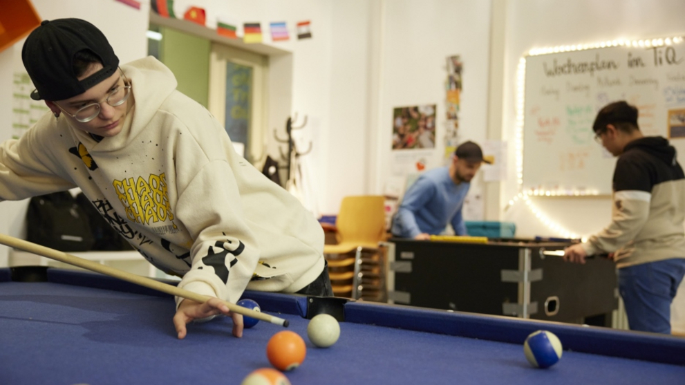 Foosball and billiards table are occupied by the young people at Tiq in no time