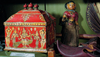 Details from the India cupboard of the Wunderkammer: a richly decorated idol box next to an Indian shoe and a doll