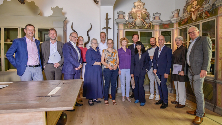 Group photo of the members of the Alliance of Early Universal Museums in the Francke Foundations' Cabinet of Artefacts and Natural Curiosities.