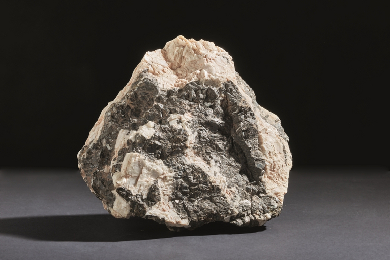 Dark ore pervades the light mineral