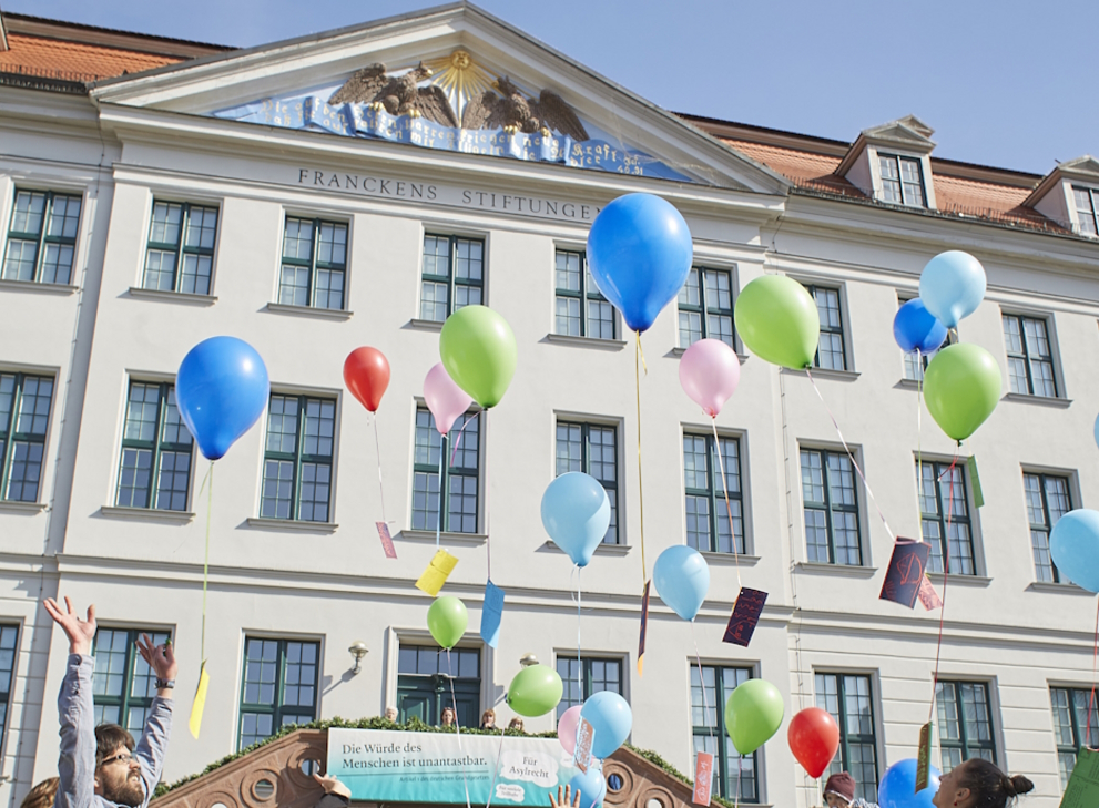 Balloons with drawings and wishes from the children of the Krokoseum are released in front of the façade of the Historic Orphanage.